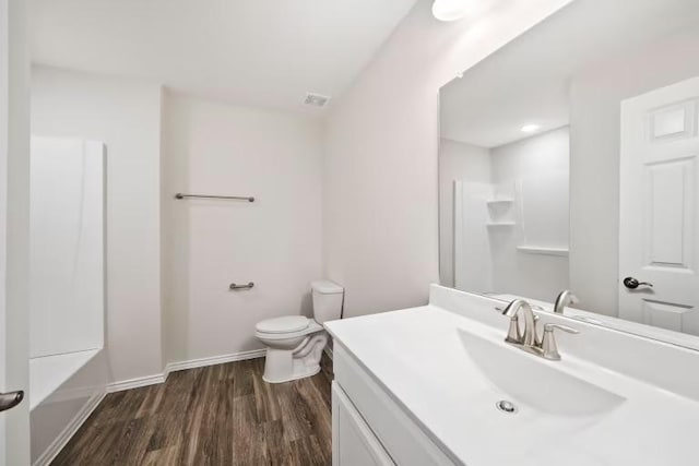 312 Singing Dove Way, Liberty Hill, TX 78642 - full bathroom with vanity, wood finished floors, and a shower