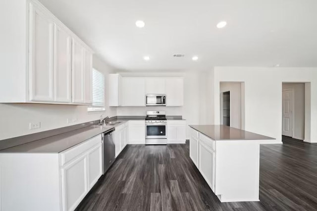 312 Singing Dove Way, Liberty Hill, TX 78642 - kitchen with stainless steel appliances, dark wood-type flooring, a kitchen island, white cabinets, and recessed lighting