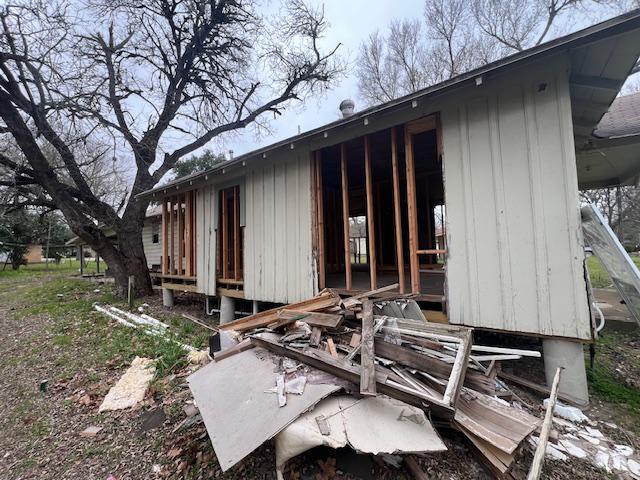 111 W Austin St, Luling, TX 78648 - rear view of property with board and batten siding