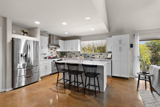 437 Venture Blvd S, Point Venture, TX 78645 - kitchen with stainless steel appliances, wall chimney exhaust hood, light countertops, a center island, and decorative backsplash