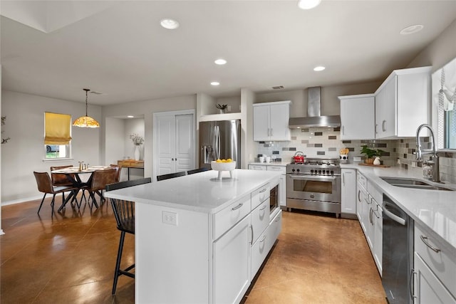 437 Venture Blvd S, Point Venture, TX 78645 - kitchen featuring wall chimney range hood, appliances with stainless steel finishes, decorative backsplash, a center island, and white cabinets