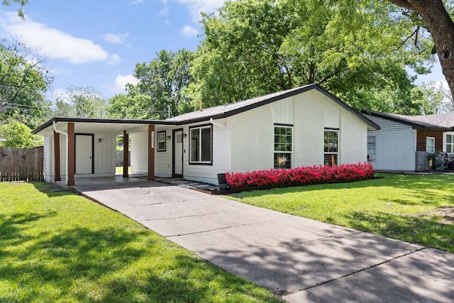 single story home with brick siding, a front lawn, driveway, and a carport