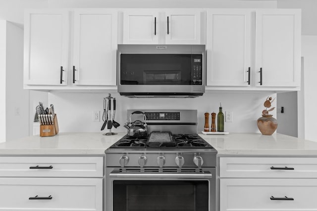 5803 Blythewood Dr, Austin, TX 78745 - kitchen with appliances with stainless steel finishes, white cabinets, and light stone counters