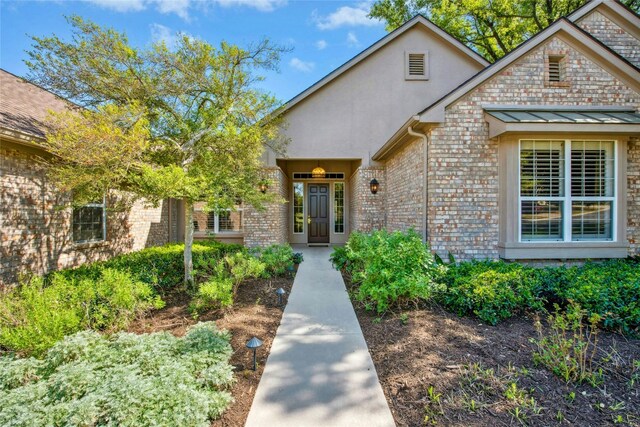 316 Trail Of The Flowers, Georgetown, TX 78633 - view of exterior entry featuring brick siding and stucco siding