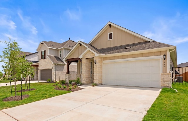 329 Singing Dove Way, Liberty Hill, TX 78642 - view of front of property featuring stone siding, board and batten siding, concrete driveway, a front yard, and a shingled roof