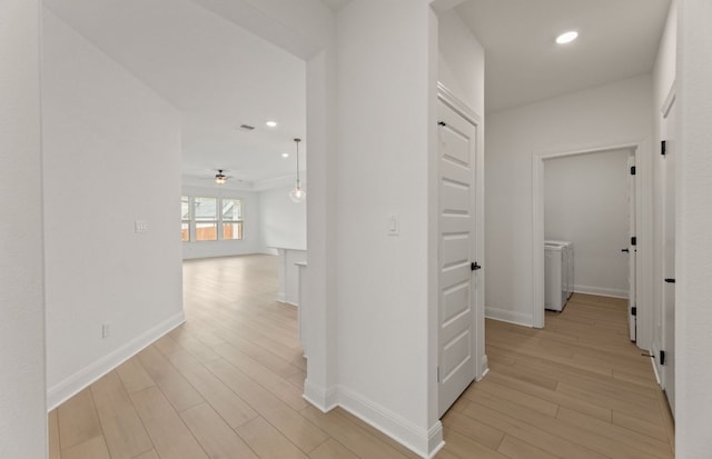 329 Singing Dove Way, Liberty Hill, TX 78642 - hall featuring light wood finished floors, washer / clothes dryer, and recessed lighting