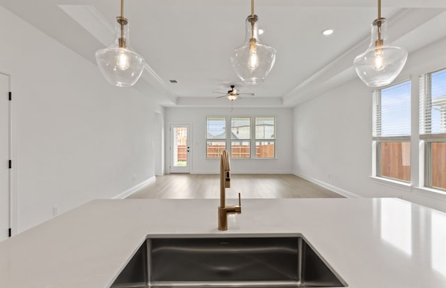 329 Singing Dove Way, Liberty Hill, TX 78642 - kitchen featuring a ceiling fan, light countertops, light wood-type flooring, hanging light fixtures, and recessed lighting