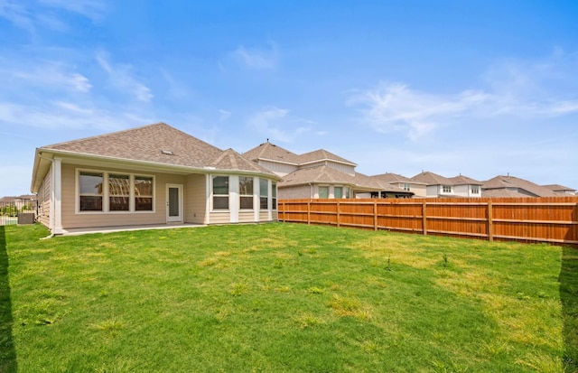 329 Singing Dove Way, Liberty Hill, TX 78642 - rear view of house with a fenced backyard, roof with shingles, and a patio