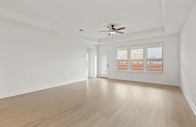 329 Singing Dove Way, Liberty Hill, TX 78642 - spare room with a ceiling fan, a raised ceiling, and light wood finished floors