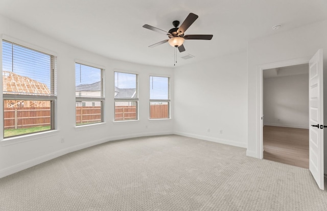 329 Singing Dove Way, Liberty Hill, TX 78642 - unfurnished room with light carpet and a ceiling fan