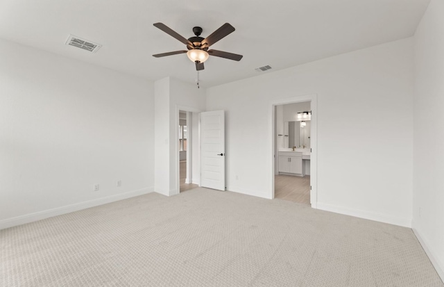 329 Singing Dove Way, Liberty Hill, TX 78642 - unfurnished bedroom with light carpet, connected bathroom, and a ceiling fan