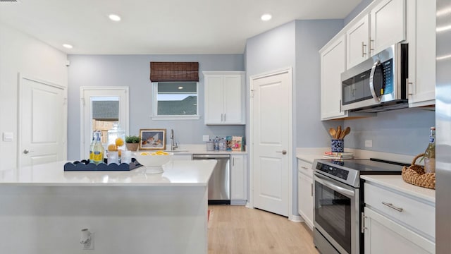2634 Caleb Asher Loop, Round Rock, TX 78665 - kitchen featuring light countertops, light wood-style flooring, appliances with stainless steel finishes, and white cabinetry