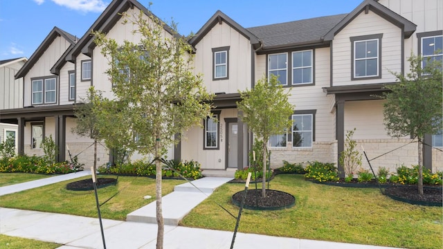 2634 Caleb Asher Loop, Round Rock, TX 78665 - view of property featuring a front lawn and board and batten siding