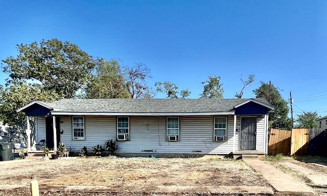 ranch-style house with cooling unit, fence, and a shingled roof