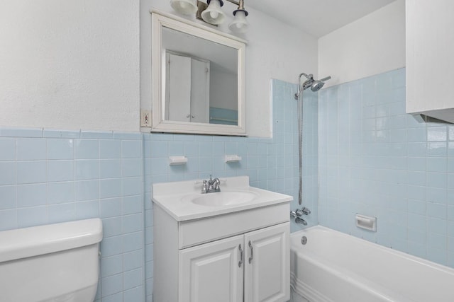 207 W 39th St, Austin, TX 78751 - bathroom with tile walls, vanity, and washtub / shower combination