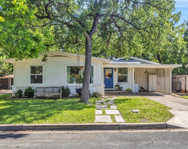 single story home with fence, an attached carport, driveway, and a front yard