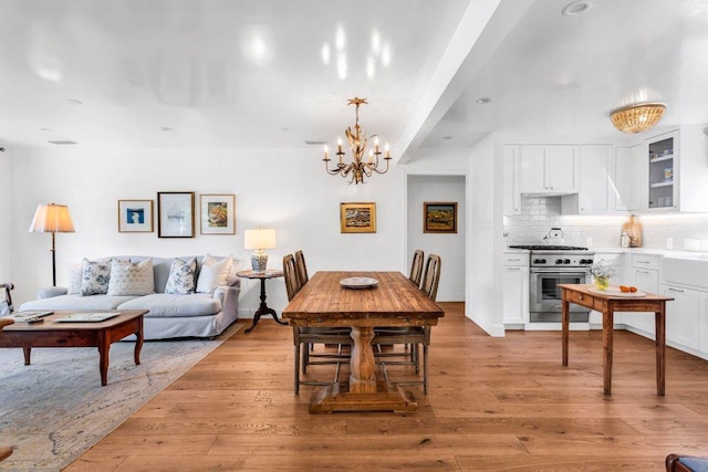 dining area featuring a chandelier and light wood-style flooring