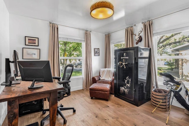 home office featuring baseboards and hardwood / wood-style flooring