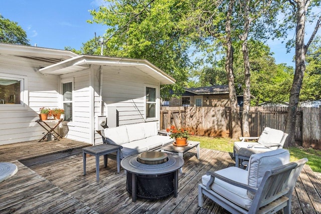 wooden deck with fence and an outdoor fire pit