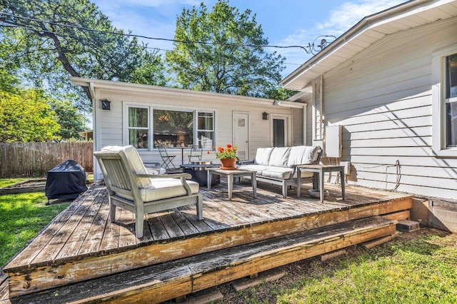 wooden terrace featuring fence and an outdoor living space