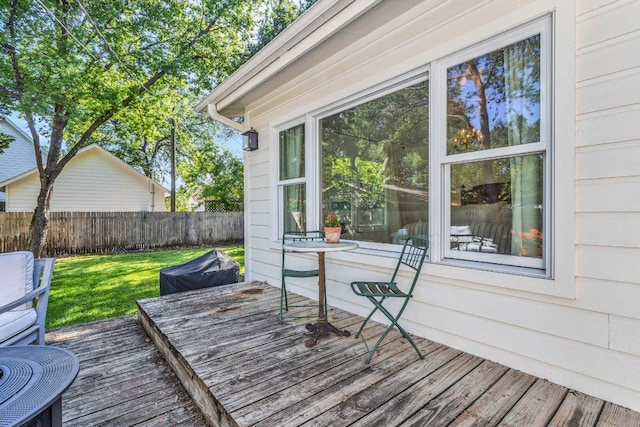 wooden terrace with fence and a yard