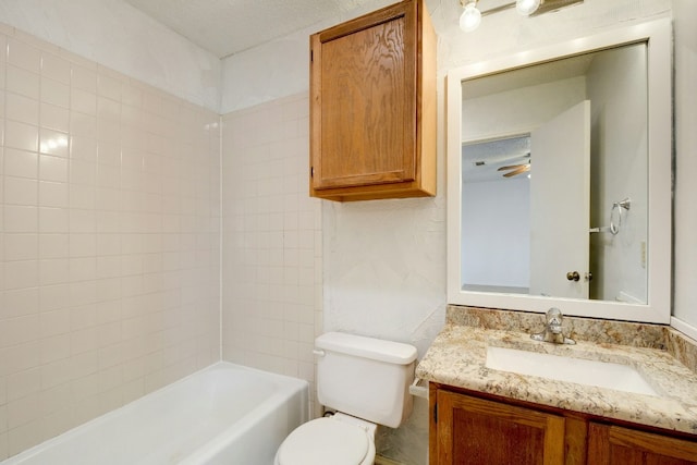 bathroom with toilet, vanity, and shower / tub combination