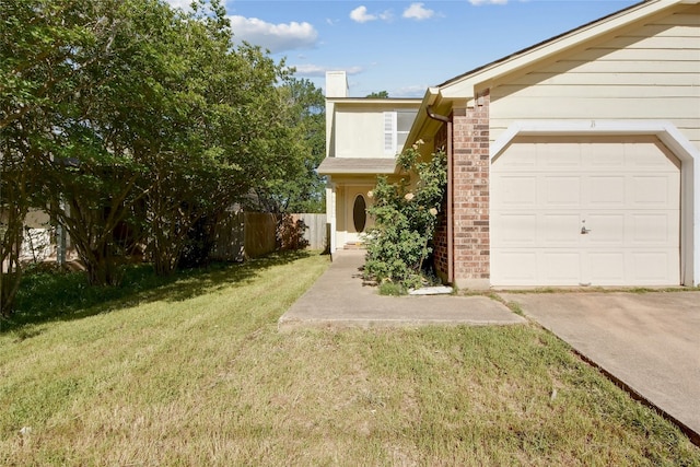 view of front of home with a front yard, an attached garage, a chimney, fence, and brick siding