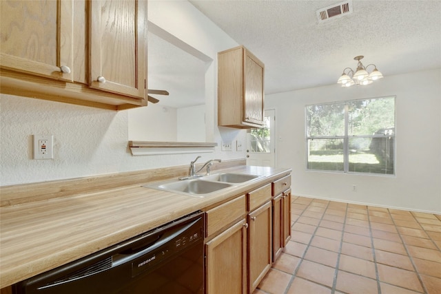 kitchen with light tile patterned floors, visible vents, dishwasher, light countertops, and a sink