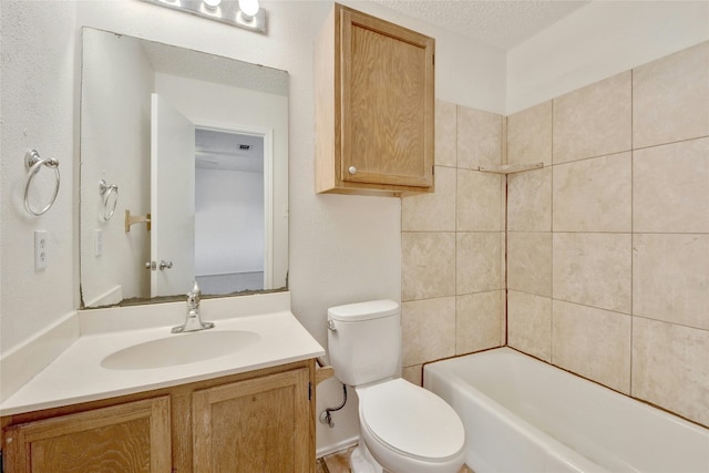 bathroom featuring vanity, shower / bathing tub combination, and toilet