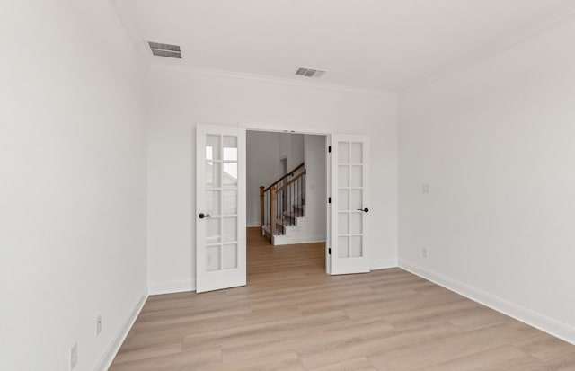 129 Elm View Dr, Georgetown, TX 78628 - empty room with crown molding, french doors, visible vents, and light wood-style flooring