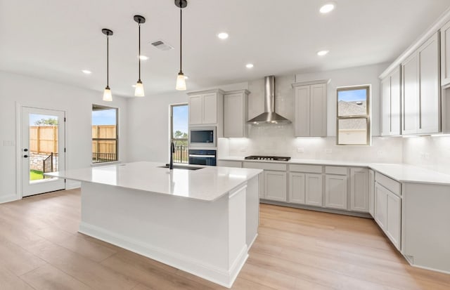129 Elm View Dr, Georgetown, TX 78628 - kitchen with wall chimney exhaust hood, oven, built in microwave, stovetop, and decorative backsplash