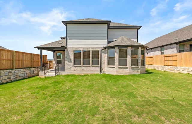 129 Elm View Dr, Georgetown, TX 78628 - back of house with a fenced backyard, roof with shingles, a yard, and a sunroom