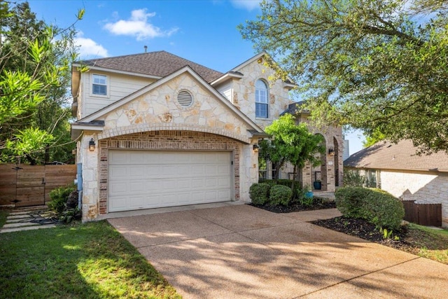 5909 Sunset Rdg, Austin, TX 78735 - view of front of home featuring driveway, an attached garage, stone siding, and brick siding