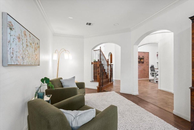 5909 Sunset Rdg, Austin, TX 78735 - living area featuring stairs, arched walkways, crown molding, wood finished floors, and baseboards