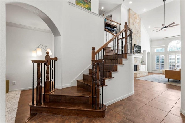 5909 Sunset Rdg, Austin, TX 78735 - staircase featuring high vaulted ceiling, crown molding, a ceiling fan, arched walkways, and baseboards