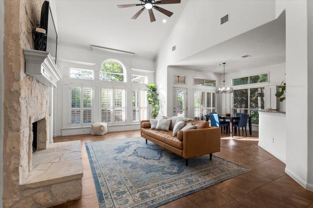5909 Sunset Rdg, Austin, TX 78735 - living room featuring high vaulted ceiling, ceiling fan, a chandelier, a stone fireplace, and ornamental molding