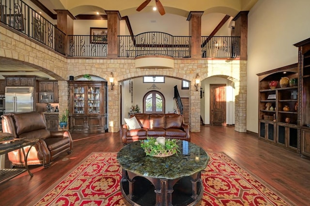 1298 Mystic Pkwy, Spring Branch, TX 78070 - living area with arched walkways, a high ceiling, wood finished floors, decorative columns, and a ceiling fan