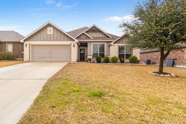 1310 Neuberry Clf, Temple, TX 76502 - craftsman-style house with board and batten siding, a garage, driveway, and a front yard