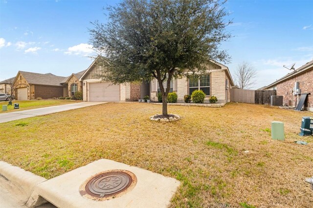 1310 Neuberry Clf, Temple, TX 76502 - view of front of property with central AC unit, concrete driveway, and an attached garage