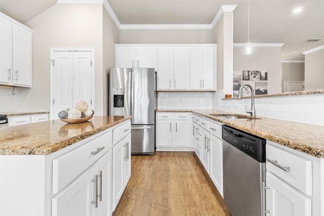 1310 Neuberry Clf, Temple, TX 76502 - kitchen with stainless steel appliances, a sink, light wood finished floors, light stone countertops, and crown molding