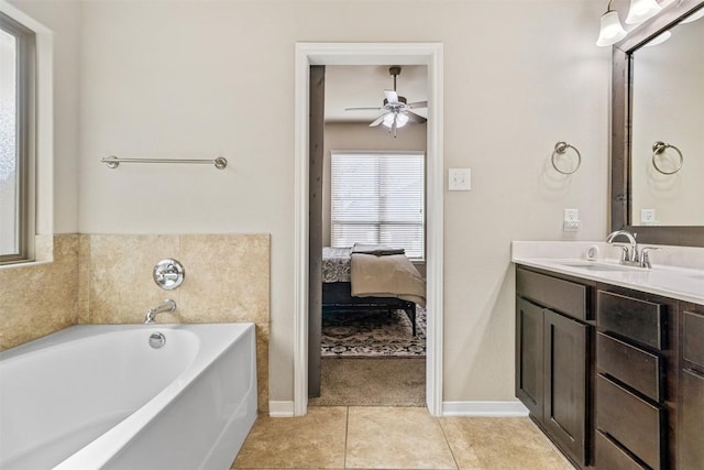 1310 Neuberry Clf, Temple, TX 76502 - ensuite bathroom featuring vanity, a garden tub, tile patterned flooring, ceiling fan, and baseboards
