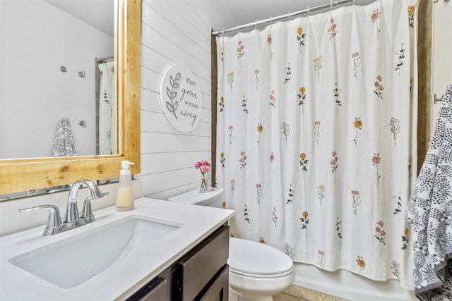 1310 Neuberry Clf, Temple, TX 76502 - full bath featuring toilet, vanity, wood walls, and shower / bath combo with shower curtain