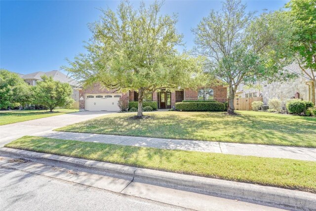 2801 Mirasol Dr, Round Rock, TX 78681 - obstructed view of property featuring driveway, an attached garage, and brick siding