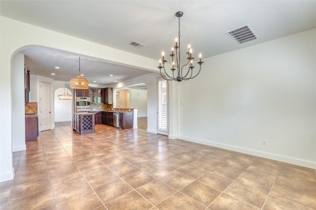 2801 Mirasol Dr, Round Rock, TX 78681 - unfurnished living room featuring arched walkways, a chandelier, baseboards, tile patterned floors, and recessed lighting