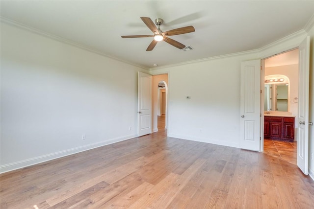 2801 Mirasol Dr, Round Rock, TX 78681 - unfurnished room featuring ornamental molding, a ceiling fan, light wood finished floors, and arched walkways