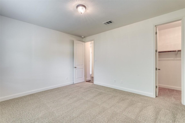 2801 Mirasol Dr, Round Rock, TX 78681 - unfurnished bedroom featuring carpet, a walk in closet, and a closet