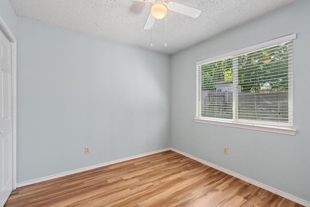 840 Eagles Way, Leander, TX 78641 - unfurnished bedroom with wood finished floors, a textured ceiling, and ceiling fan