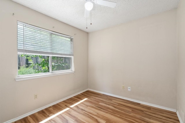 840 Eagles Way, Leander, TX 78641 - spare room featuring plenty of natural light, a textured ceiling, and wood finished floors