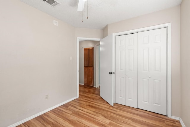 840 Eagles Way, Leander, TX 78641 - unfurnished bedroom featuring light wood finished floors, a closet, and a ceiling fan