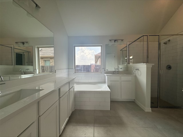 493 Sugar Cane Rd, Buda, TX 78610 - full bath featuring a stall shower, two vanities, a garden tub, and tile patterned flooring